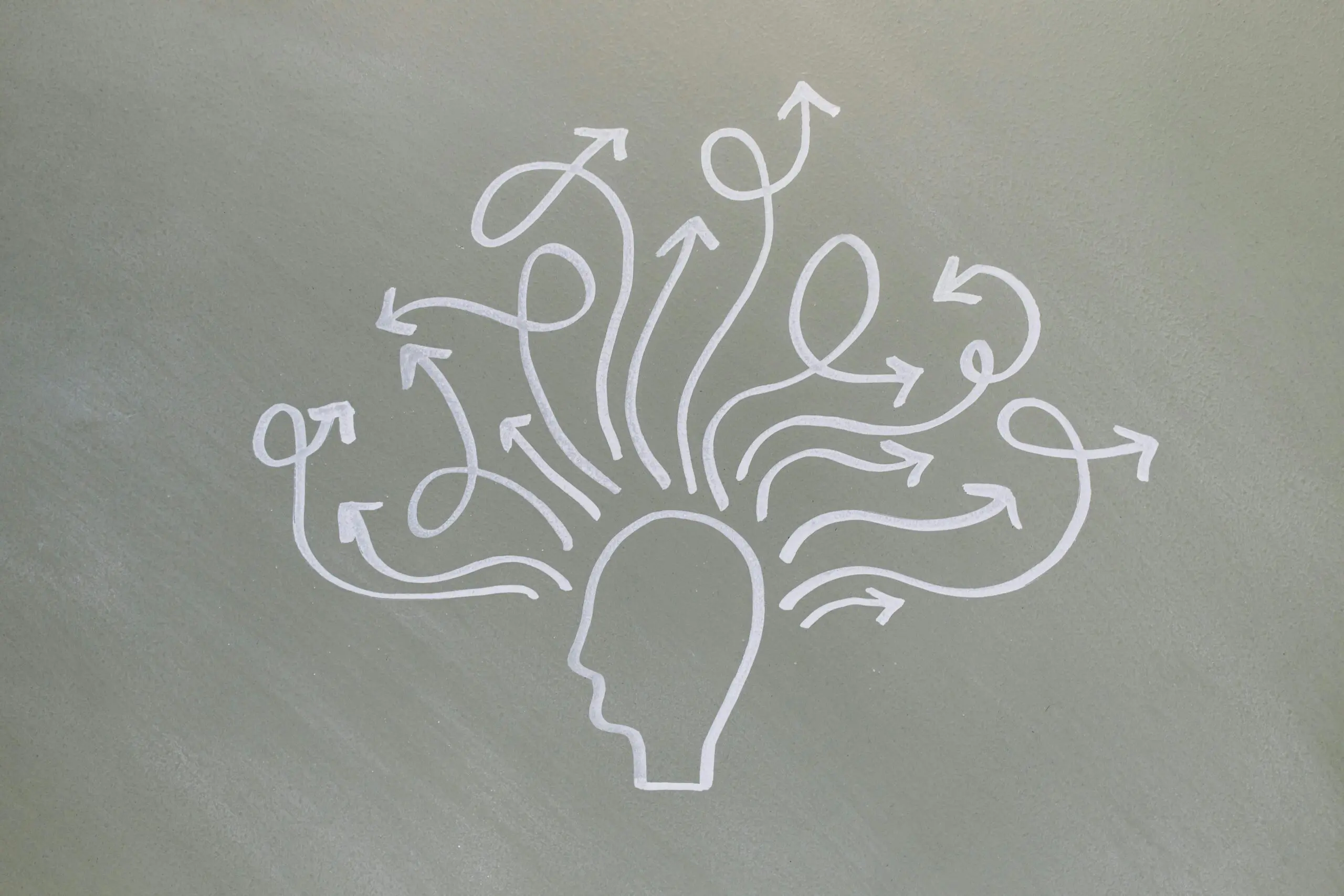 Conceptual chalk drawing illustrating mental health challenges with arrows representing thoughts.