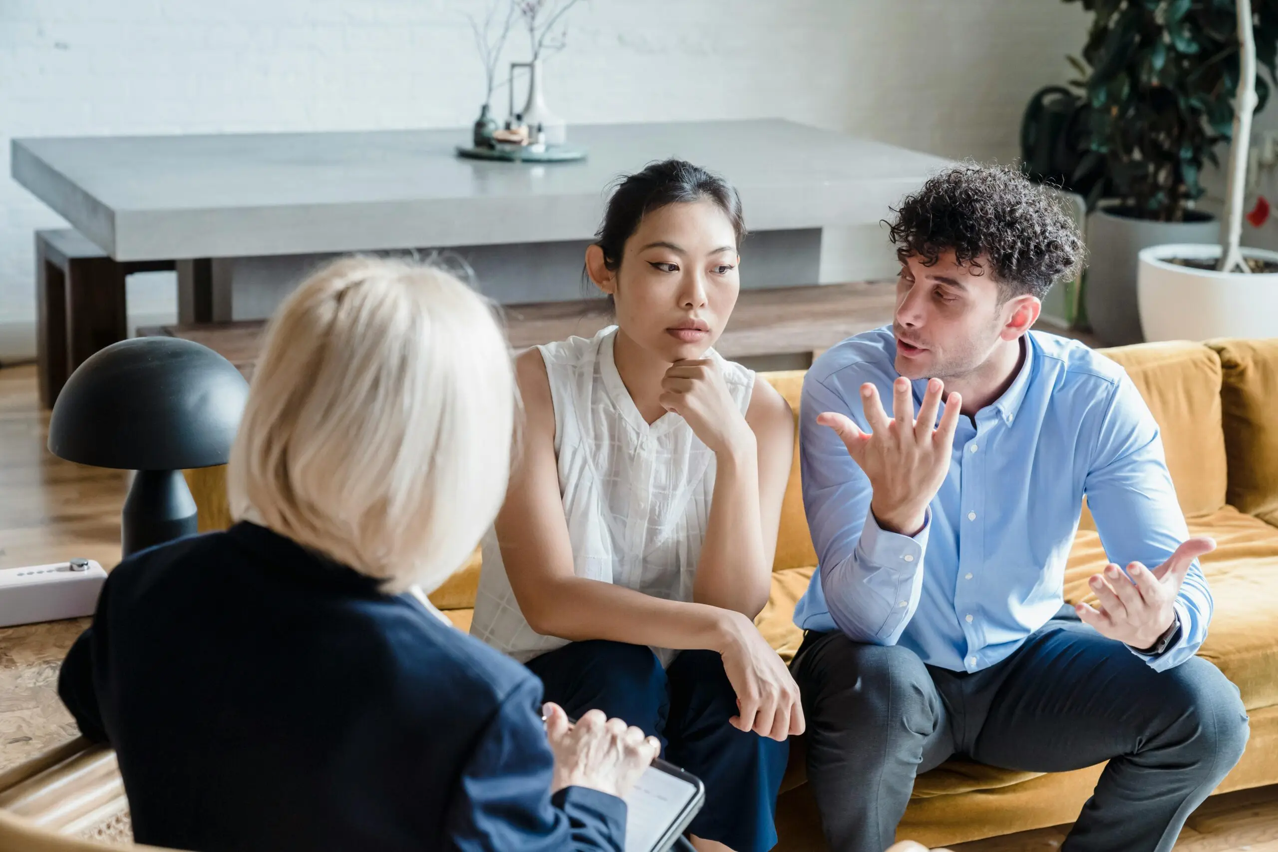 Couple discussing issues with a therapist during a counseling session.